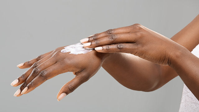 right hand applying lotion to left hand